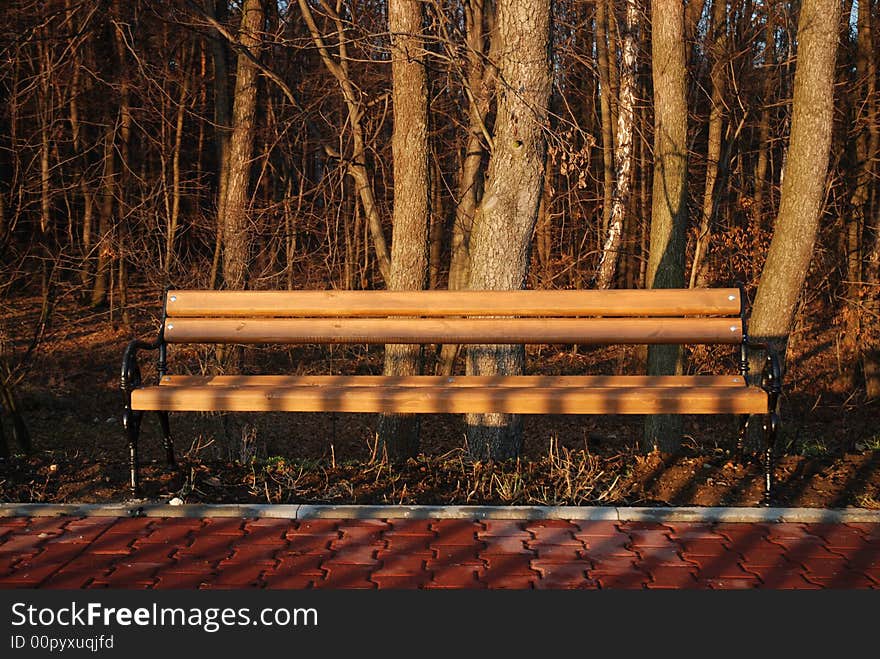 Park bench at sunset with backlight