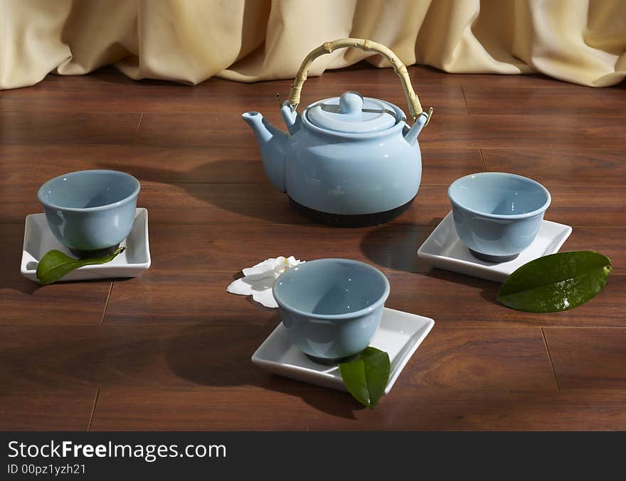 Tea set on parquet floor. Tea set on parquet floor