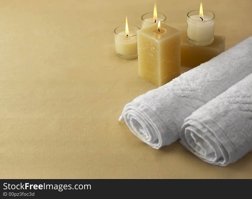 Candles and towels on brown background. Candles and towels on brown background