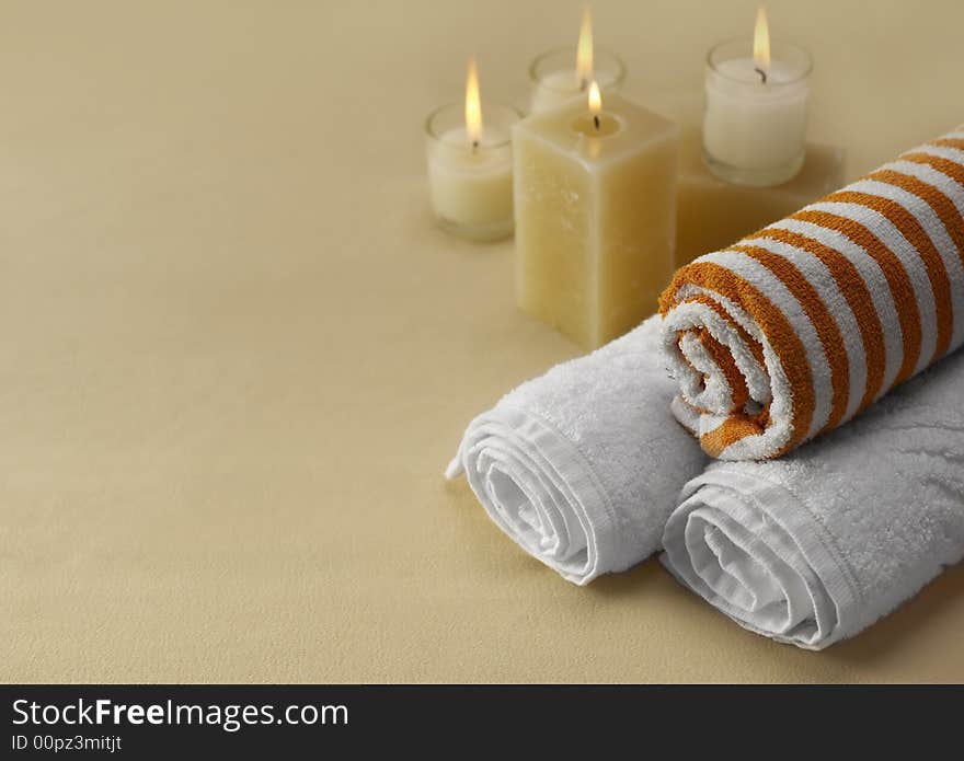 Candles and towels on brown background. Candles and towels on brown background