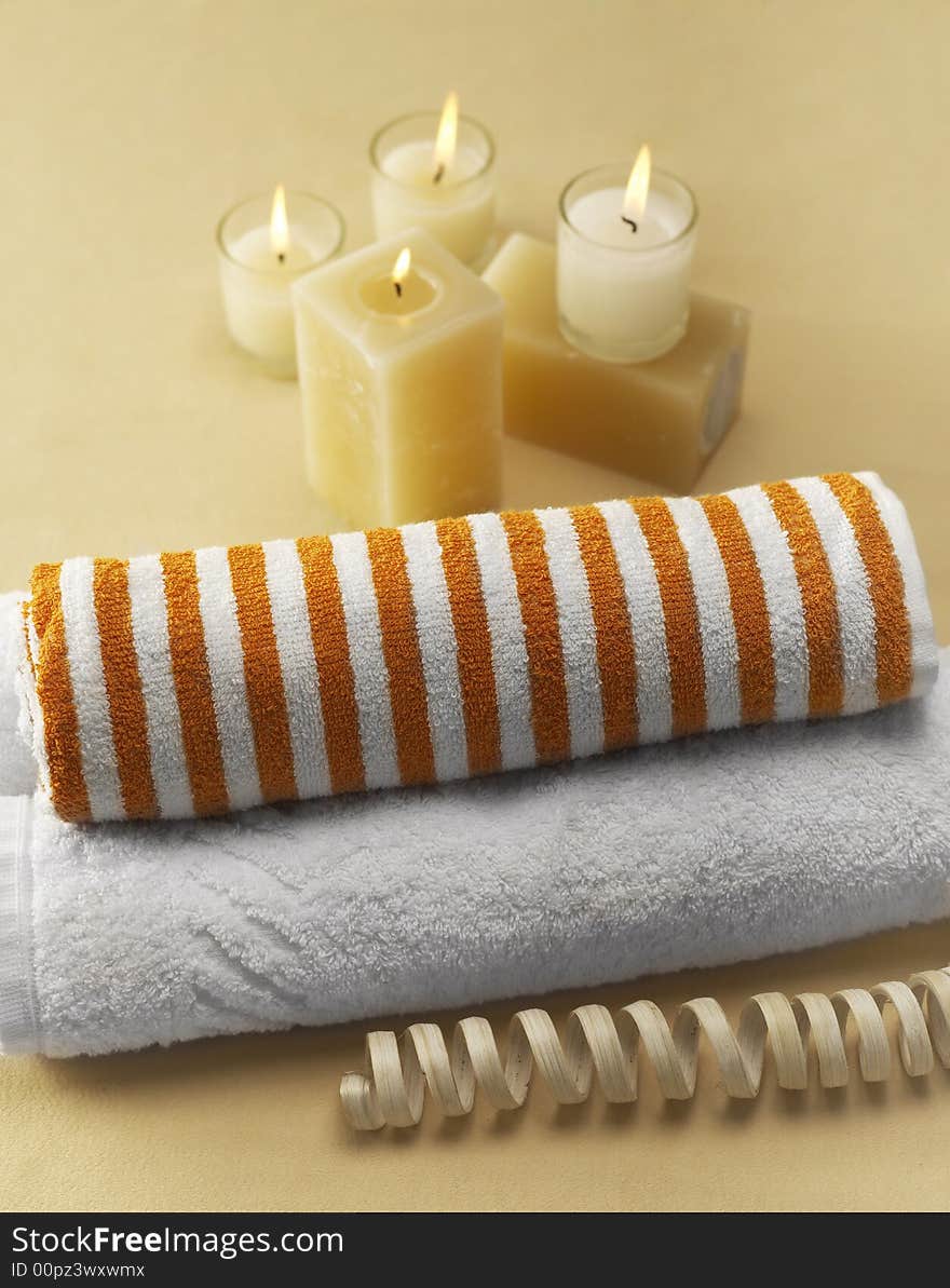 Candles and towels on brown background. Candles and towels on brown background