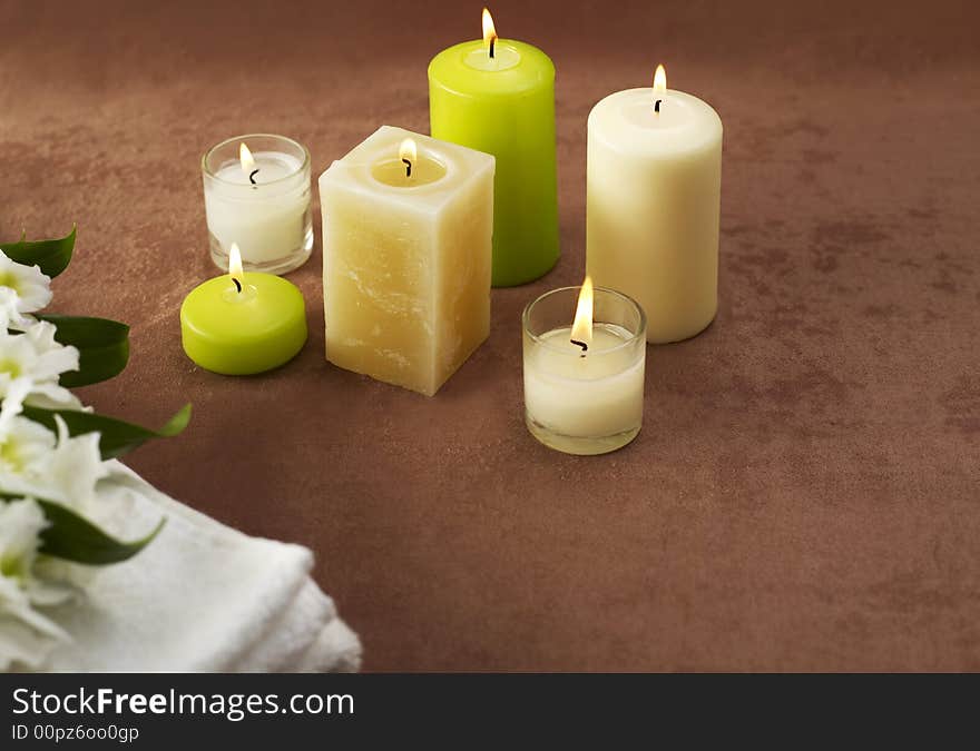 Candles and towels on brown background. Candles and towels on brown background