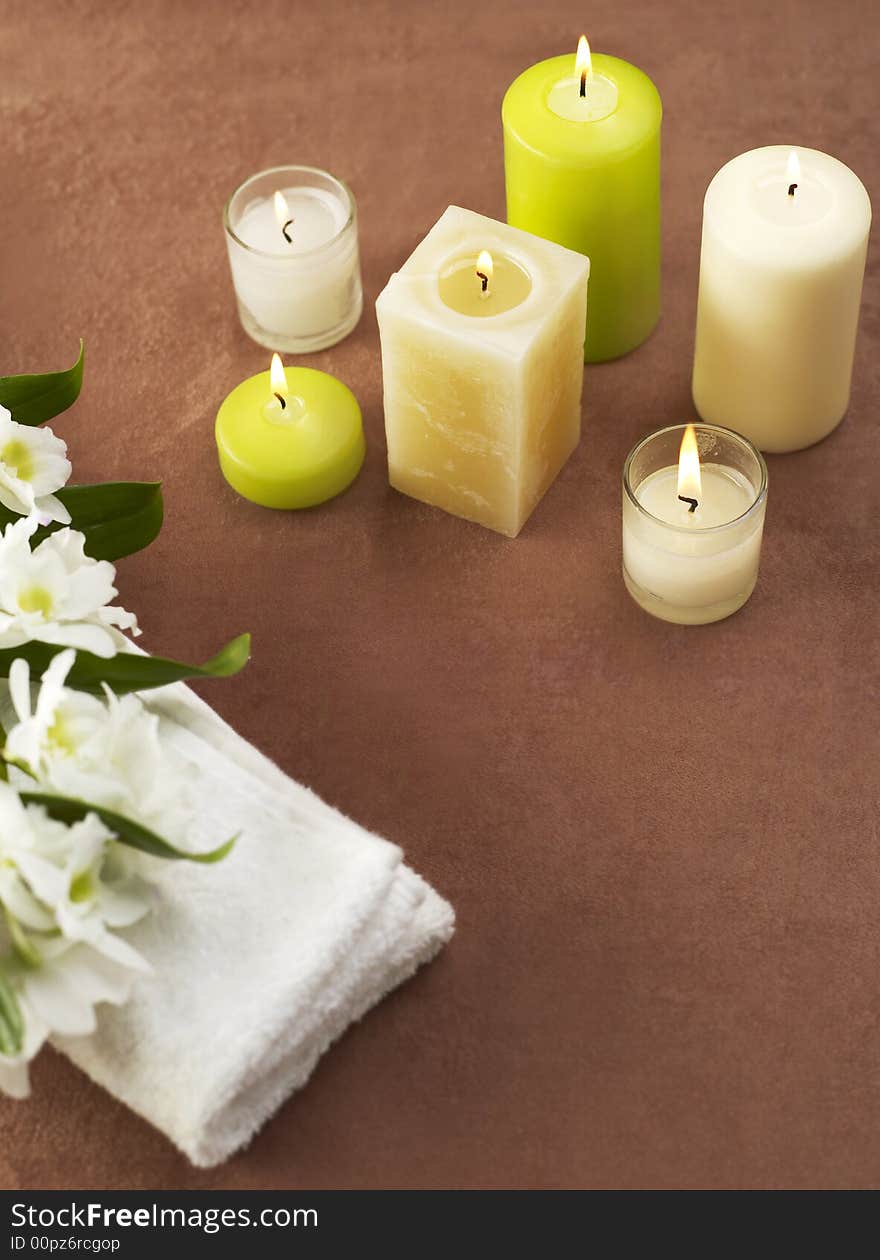 Candles and towels on brown background. Candles and towels on brown background