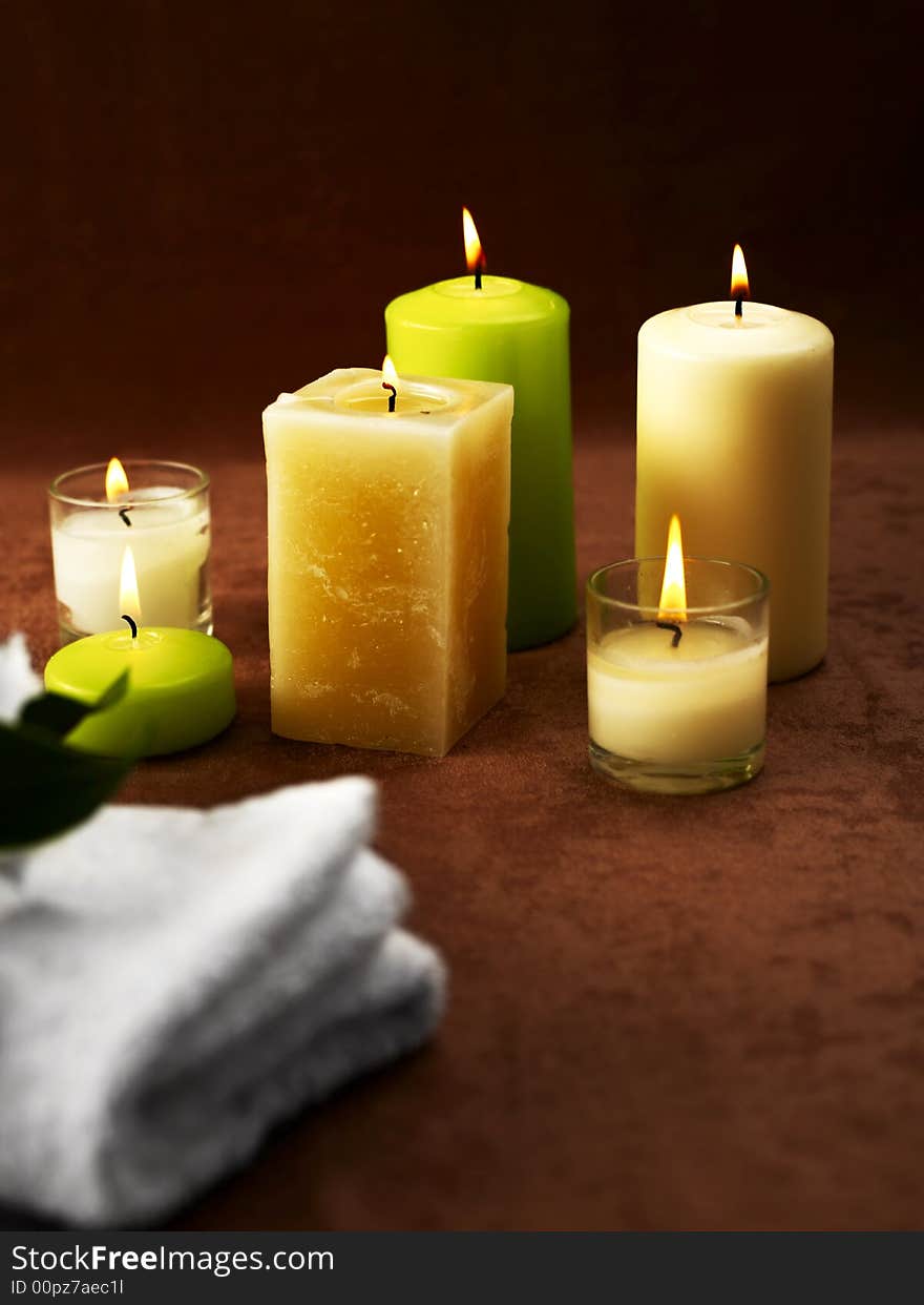 Candles and towels on brown background. Candles and towels on brown background