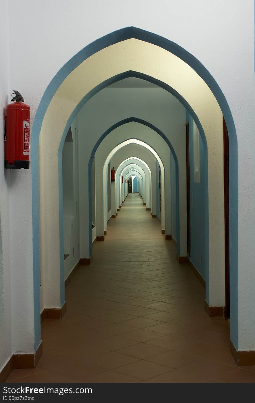 Lancet arch passage in east hotel and fire extinguisher on the wall