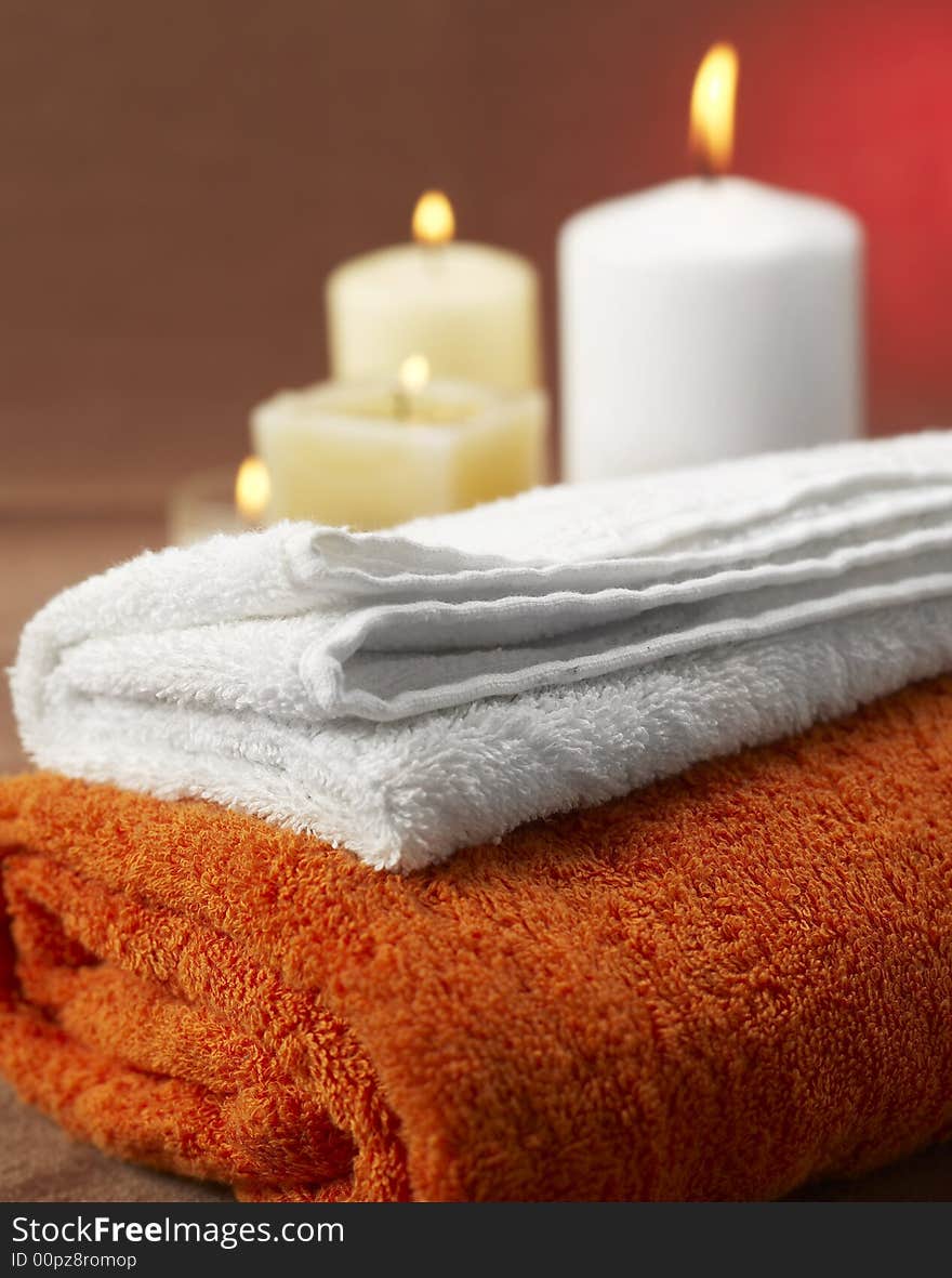 Candles and towels on brown background. Candles and towels on brown background