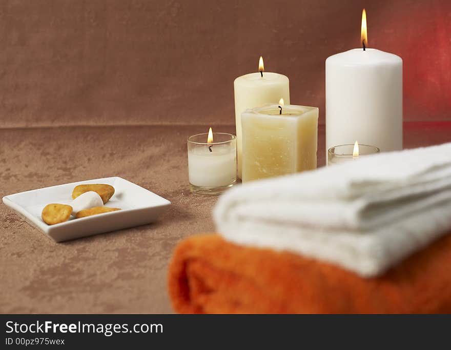 Candles and towels on brown background. Candles and towels on brown background