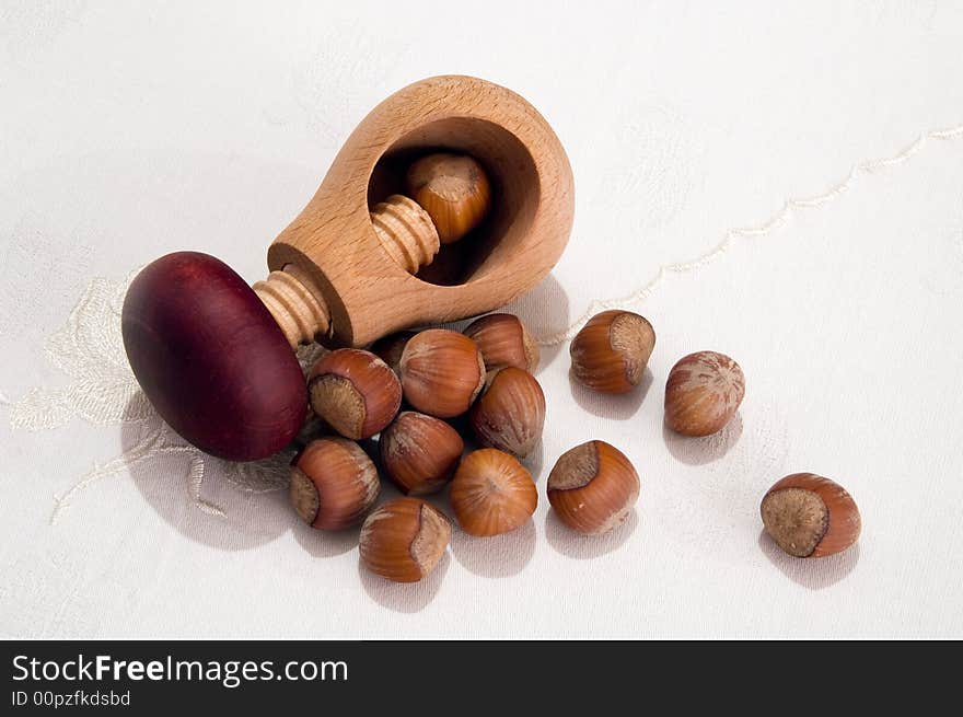 Hazelnuts and screw-cracker on table