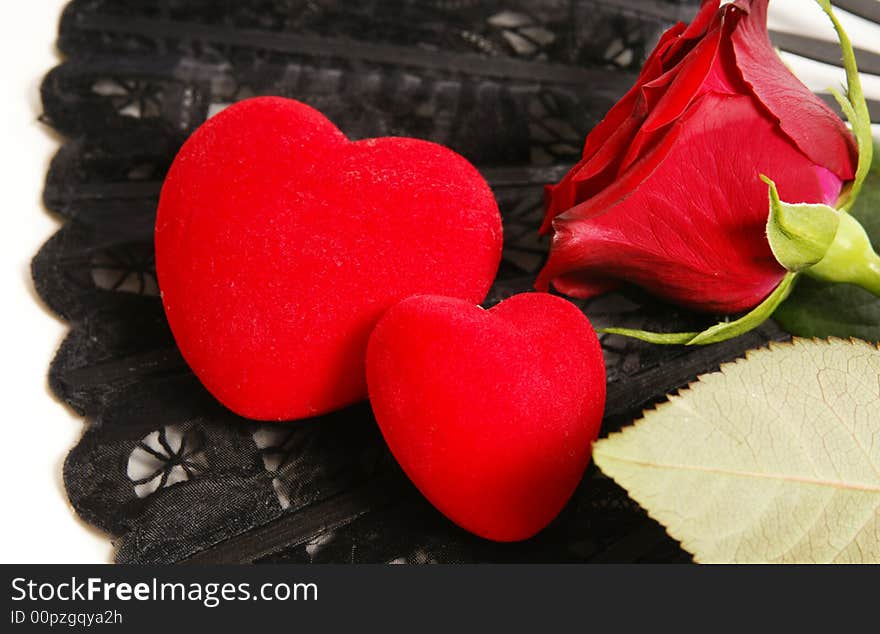 Single red rose on a dark background with hearts. Single red rose on a dark background with hearts