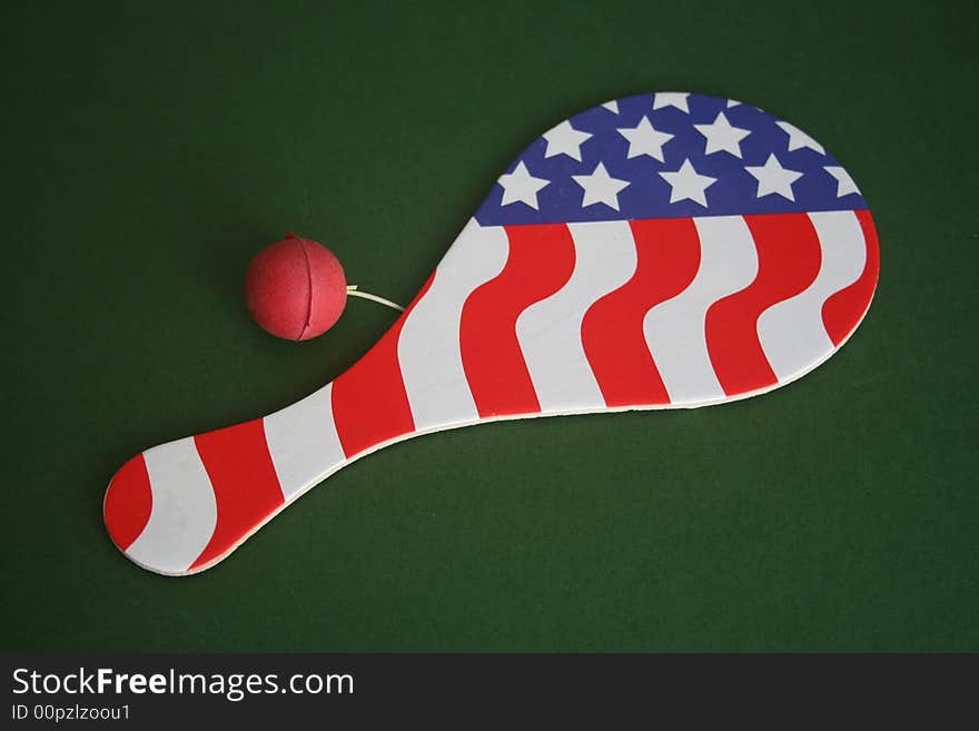 Paddle ball with the American flag over green background