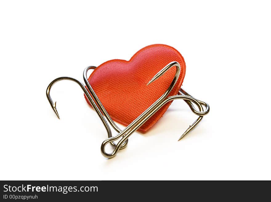 Red heart with a fishing hook on a white background