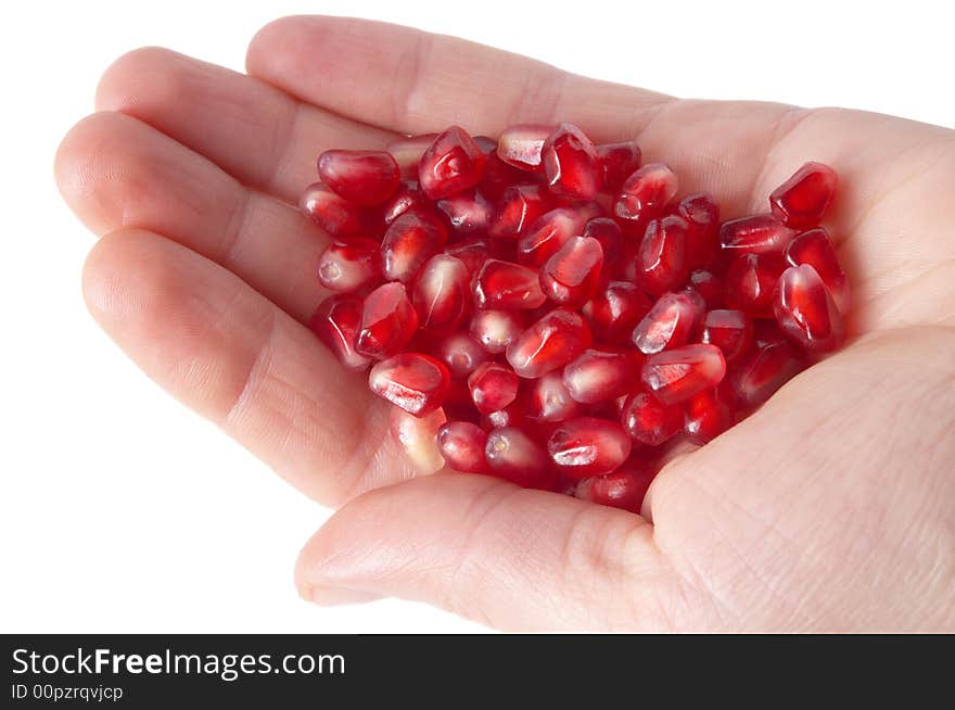 Red ripe pomegranate seeds on the human palm. Red ripe pomegranate seeds on the human palm