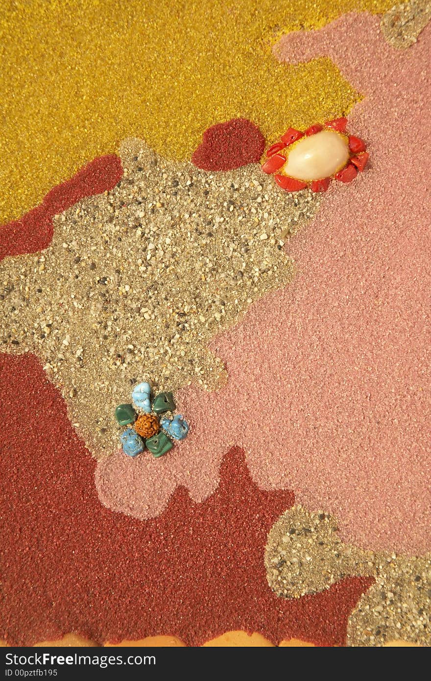 Colourful background: texture created with different kinds of sands, stones, pebbles, gemstone, crystal