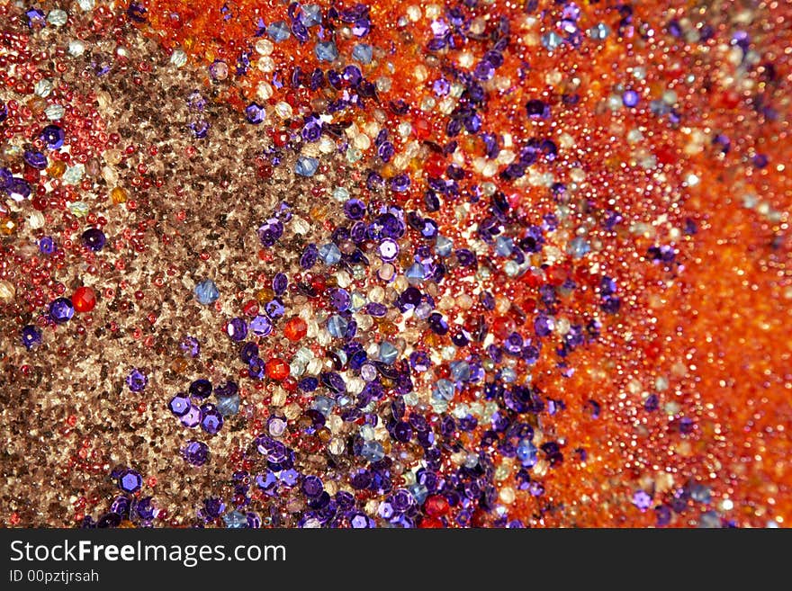 Colourful background: texture created with different kinds of sands, stones, pebbles, gemstone, crystal