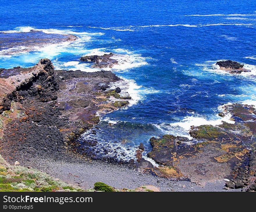 Photograph taken at Cape Schanck looking down the cliffs to the pounding ocean swell (Mornington Peninsula, Australia). Photograph taken at Cape Schanck looking down the cliffs to the pounding ocean swell (Mornington Peninsula, Australia).