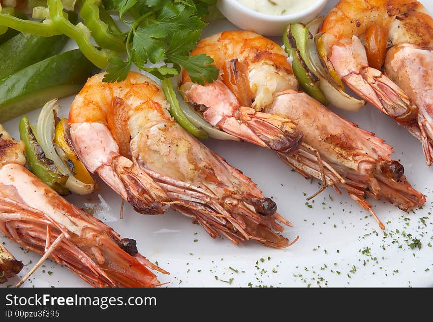 Large grilled shrimps served on plate with vegetables, selective focus. Large grilled shrimps served on plate with vegetables, selective focus