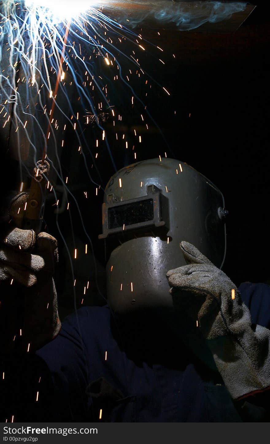 A welder working at shipyard at night. A welder working at shipyard at night