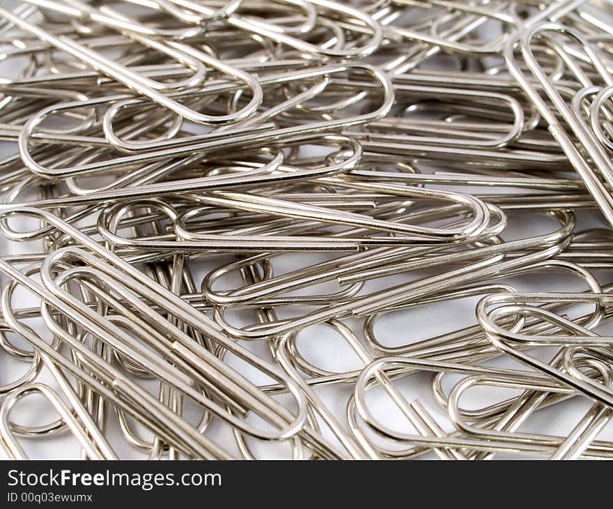 A macro shot of spread out metal paper clips. A macro shot of spread out metal paper clips