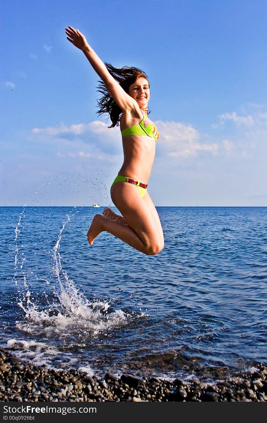 Pretty jumping woman on the sea background. Pretty jumping woman on the sea background