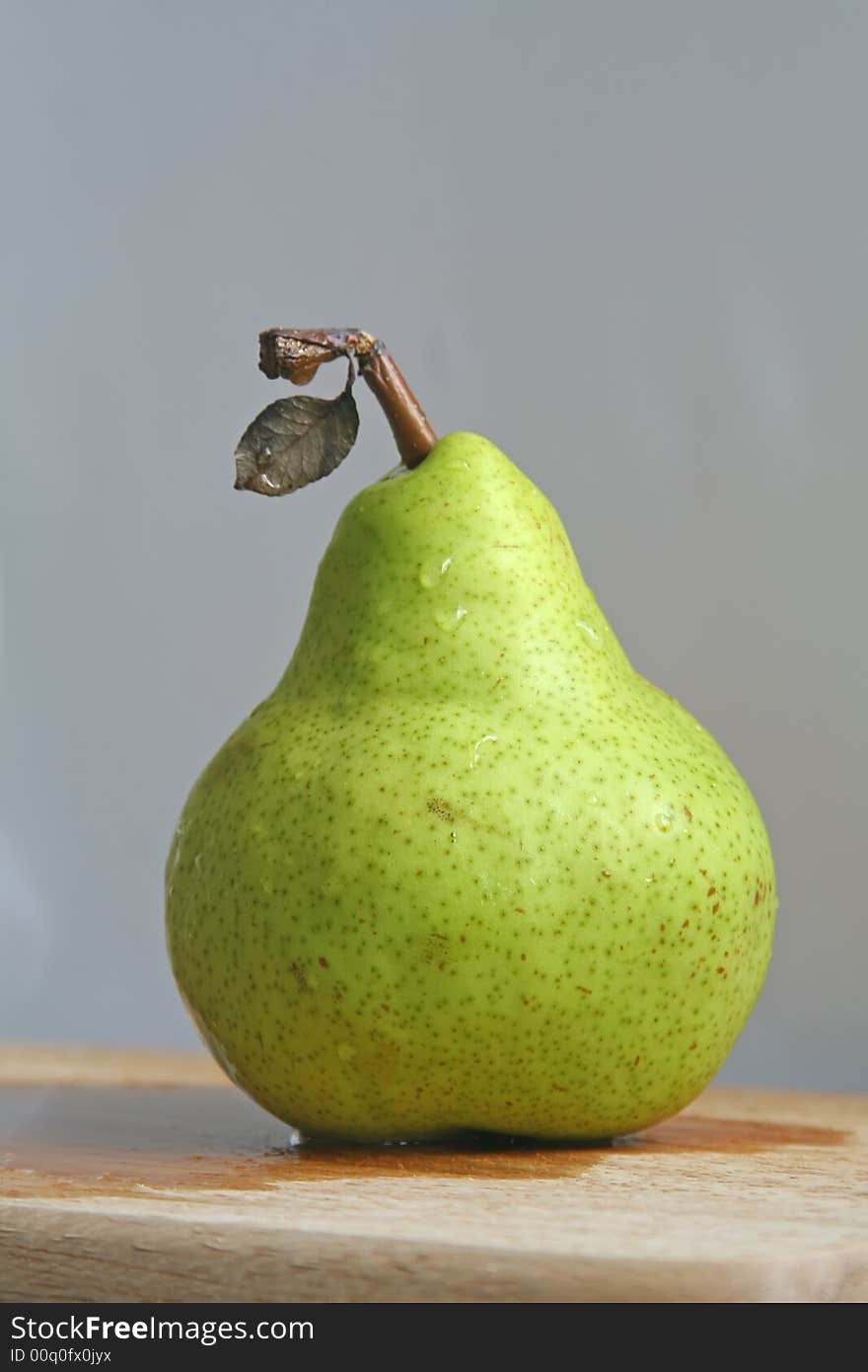 Pear with leaf still intact. Pear with leaf still intact