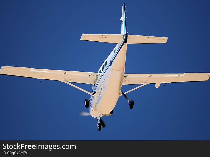 An aircraft coming into land with wheels out on final approach to airport runway. An aircraft coming into land with wheels out on final approach to airport runway