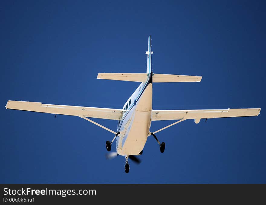 An aircraft coming into land with wheels out on final approach to airport runway. An aircraft coming into land with wheels out on final approach to airport runway