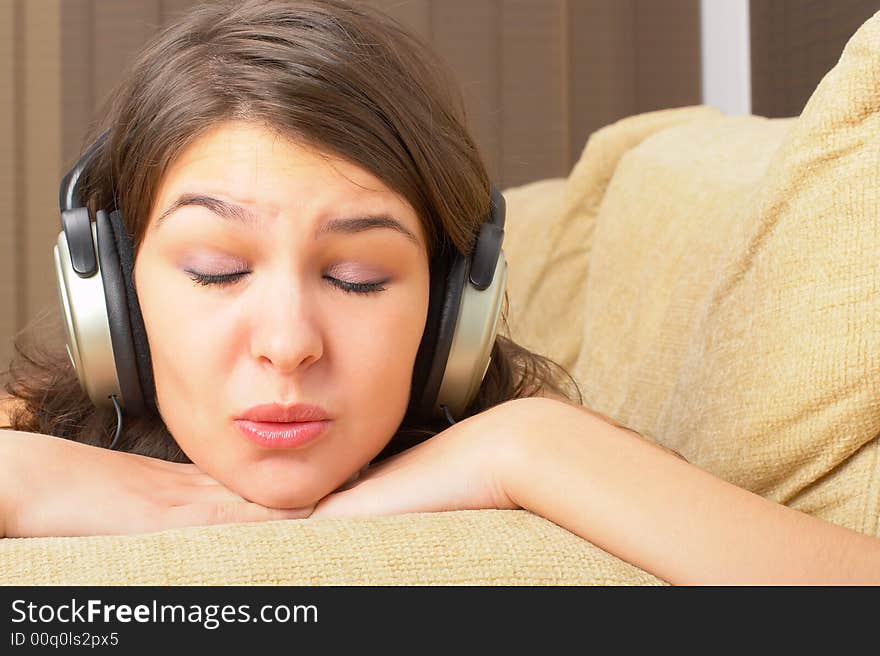 Young Girl enjoys listening music in headphones