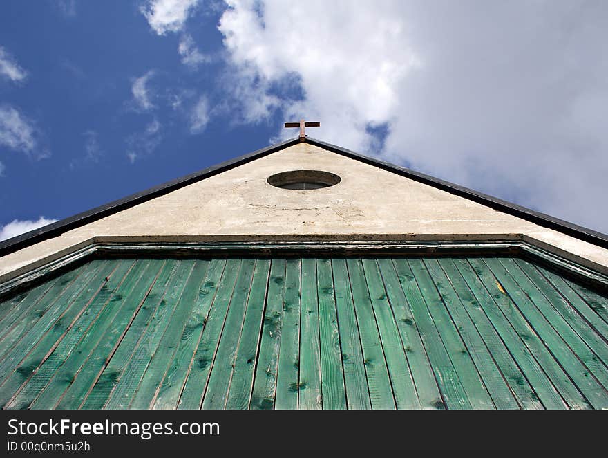 Rural mountain wooden church detail with blue sky background. Rural mountain wooden church detail with blue sky background