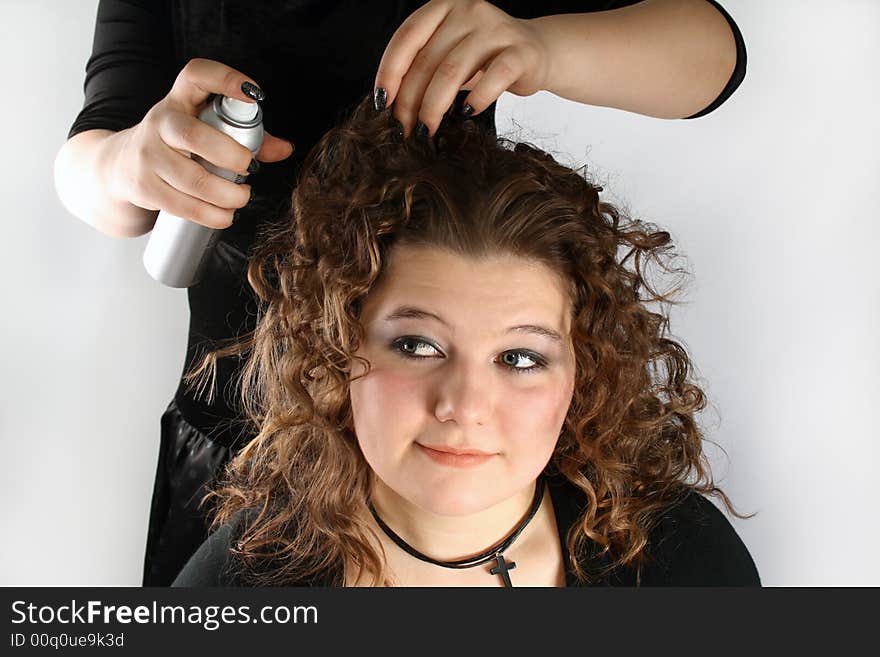 A girl getting her hair done. A girl getting her hair done