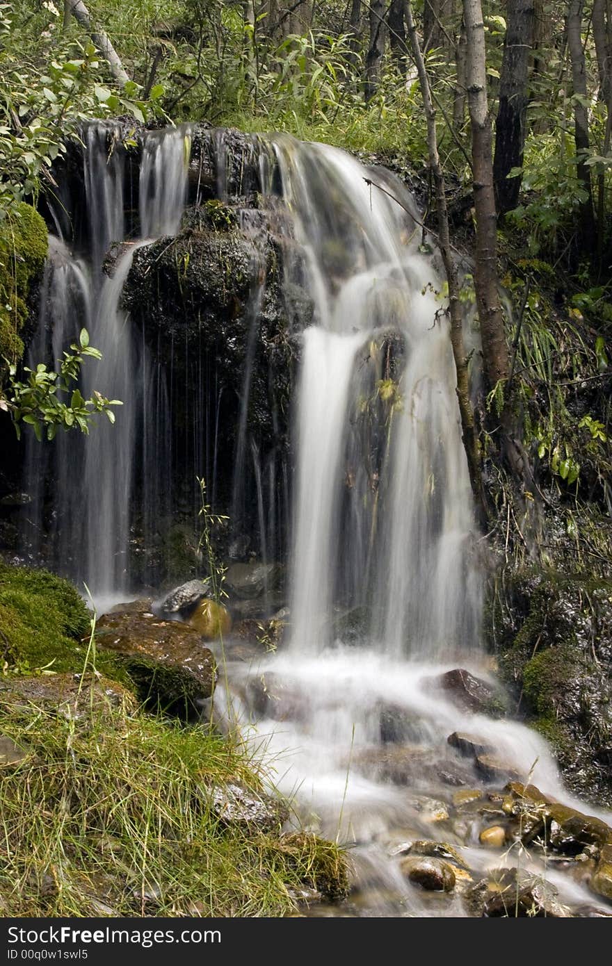 A very small waterfall by the side of the road. A very small waterfall by the side of the road.