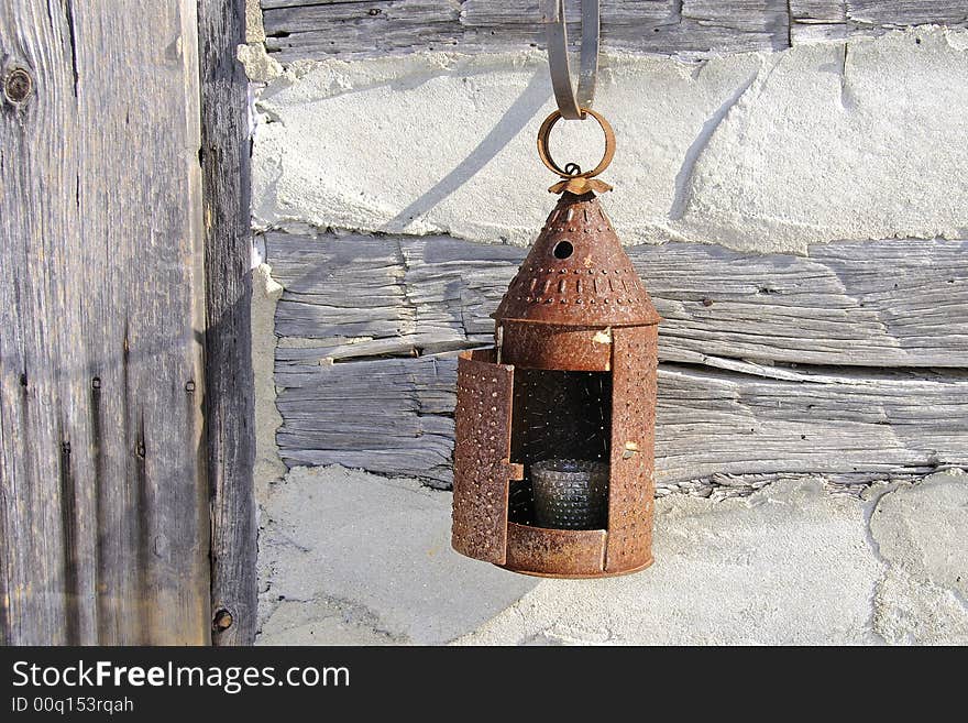 Paul Revere tin lantern hung out side the front door of old log cabin. Beautiful design form simpler times. Paul Revere tin lantern hung out side the front door of old log cabin. Beautiful design form simpler times.