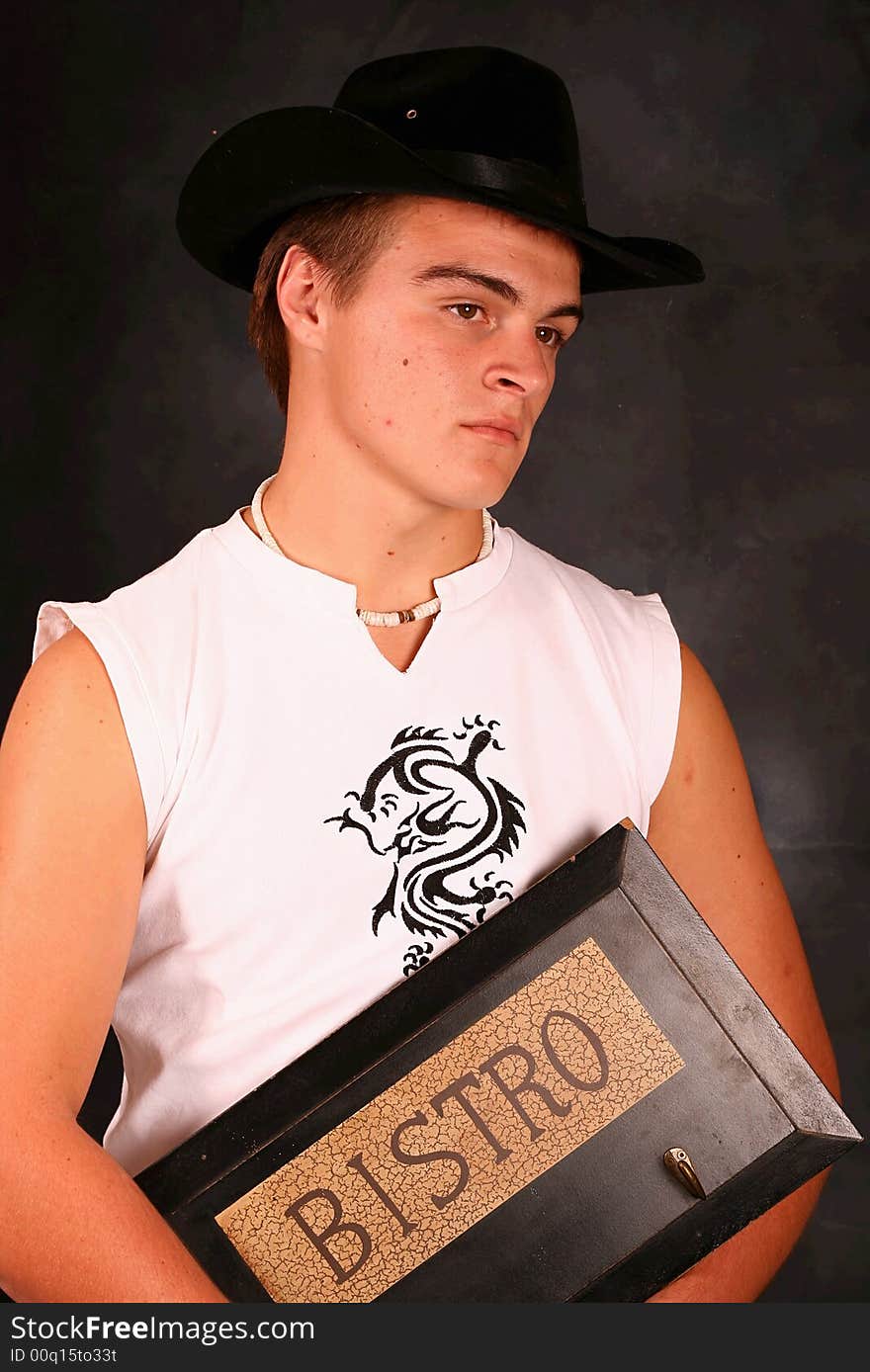 Young Male Model in white shirt holding a bistro sign. Young Male Model in white shirt holding a bistro sign.