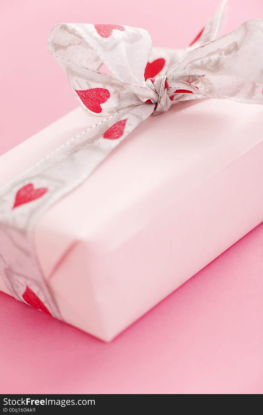 Pink gift box over a pink background