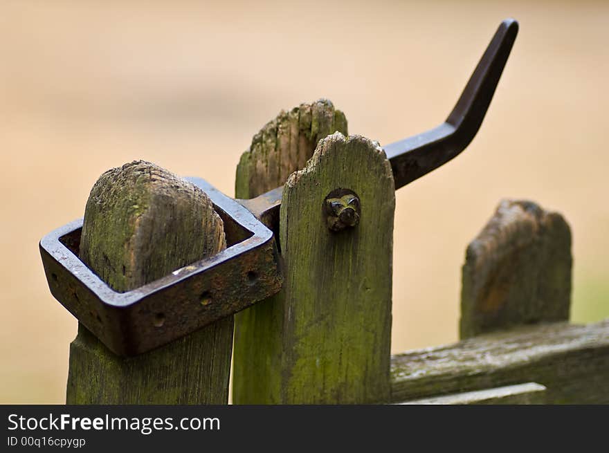 Wrought iron gate fastener - old fashiioned and worn but functional. Wrought iron gate fastener - old fashiioned and worn but functional