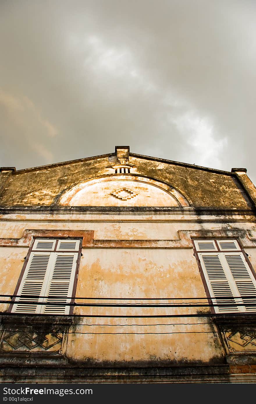 Colonial building with storm clouds