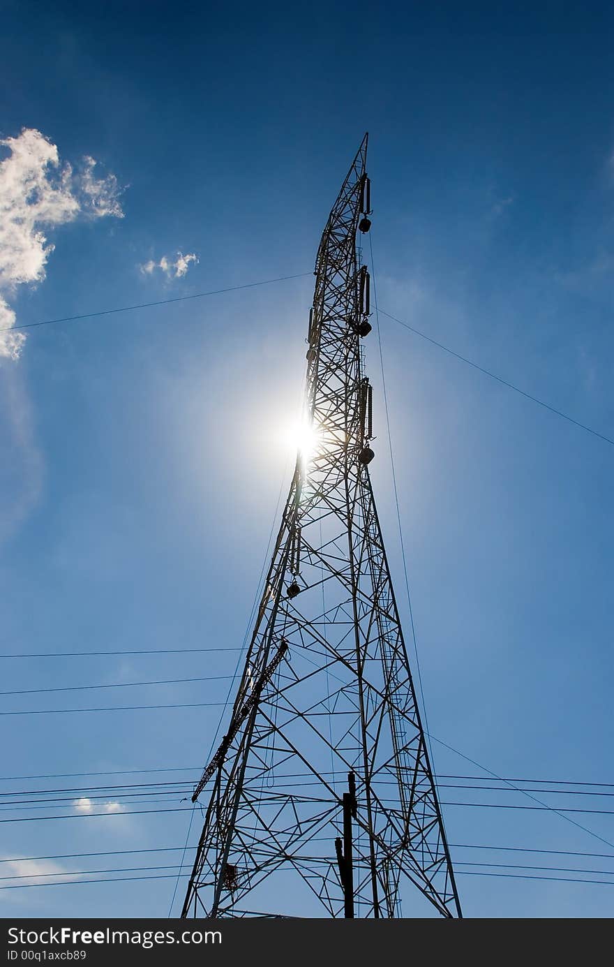 Electric tower with sun and blue sky. Electric tower with sun and blue sky