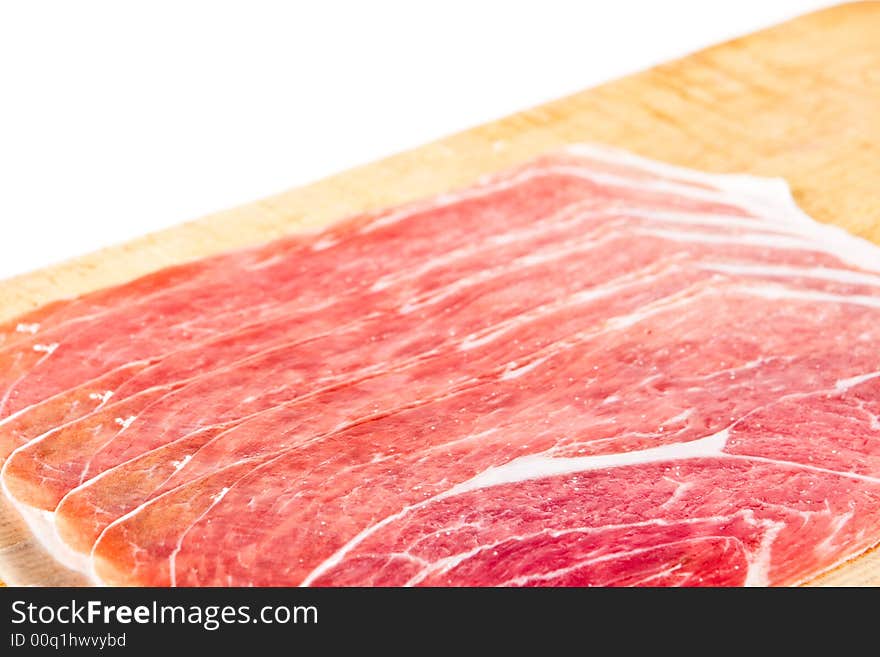 Parma ham on a wooden chopping block