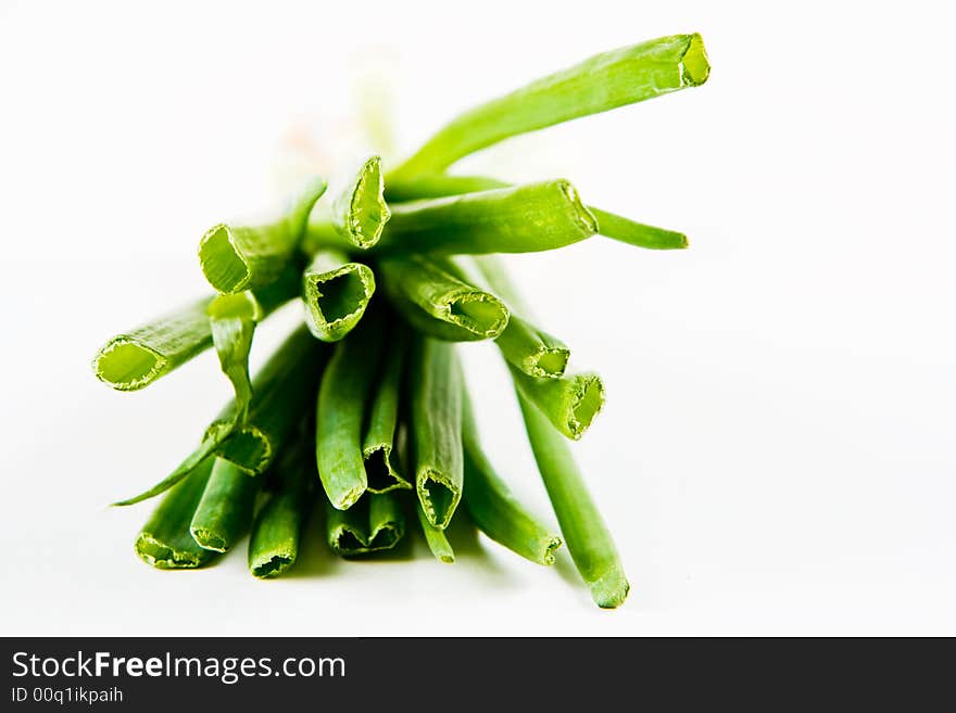 A bunch of spring onions on a white background