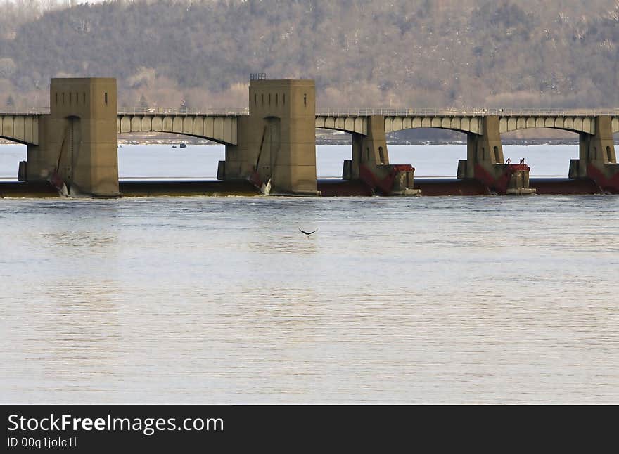 Bridge over the Mississippi River and a bald eagle flying in front of it. Bridge over the Mississippi River and a bald eagle flying in front of it.