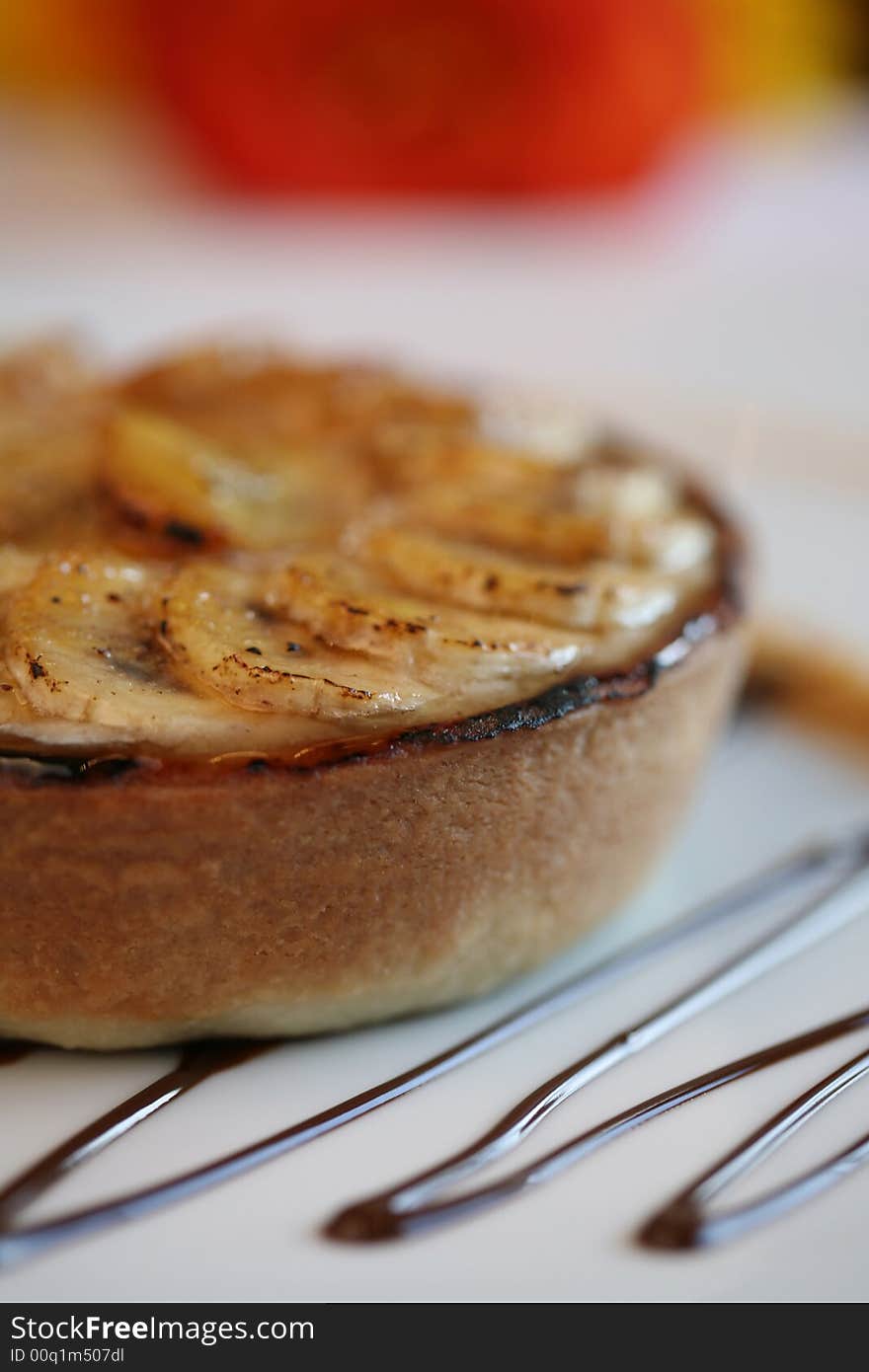 Banana tart on a chocolate pattern