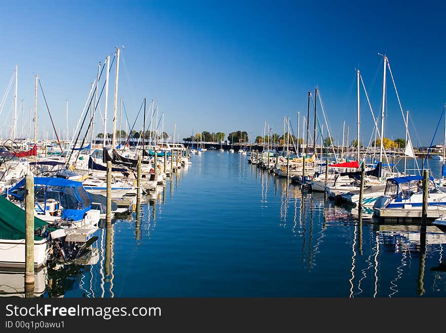 Water alley between two rows of moored boats in marina. Water alley between two rows of moored boats in marina