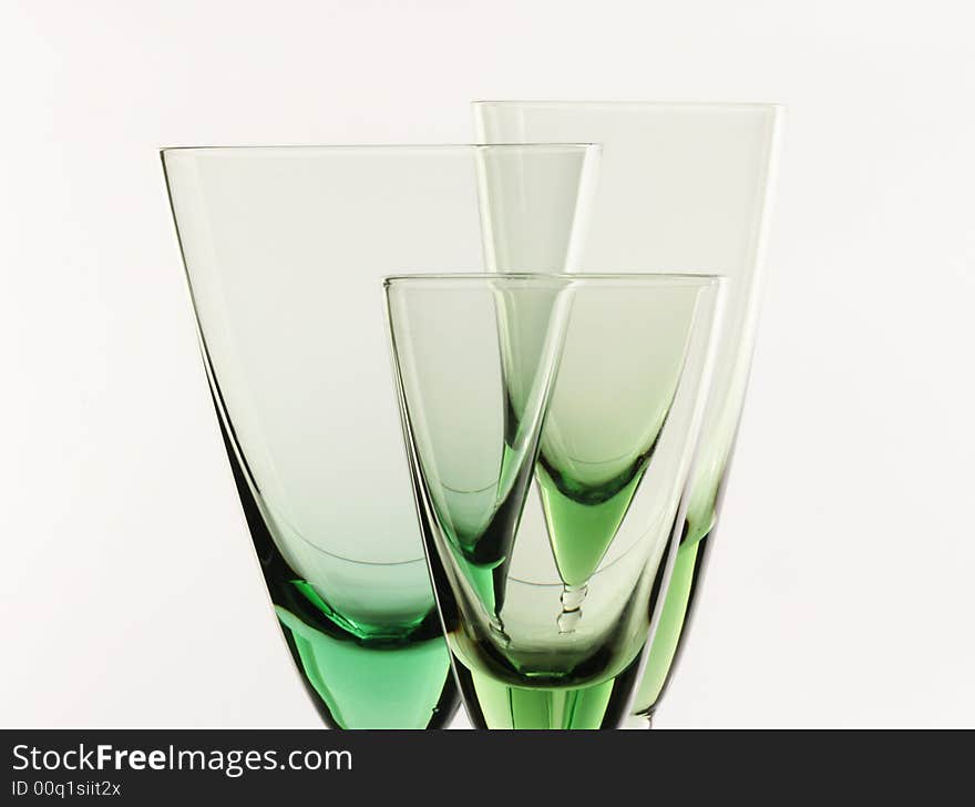 A glass beside a stack of white plates - on white background. A glass beside a stack of white plates - on white background