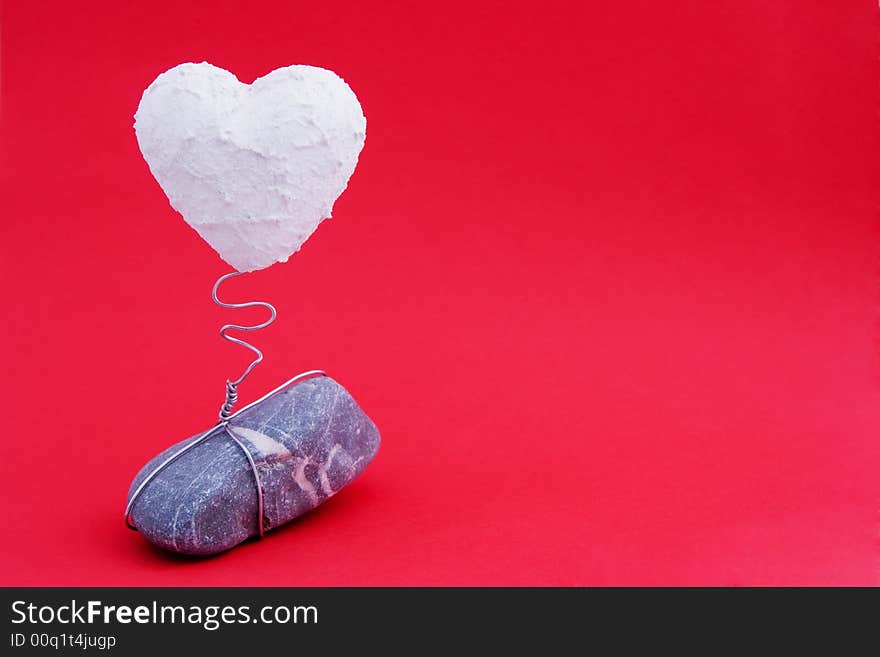 A white heart on a stone base