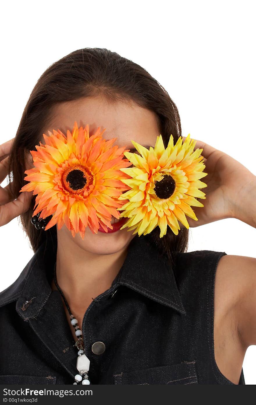 Playful girl covering her face with flowers