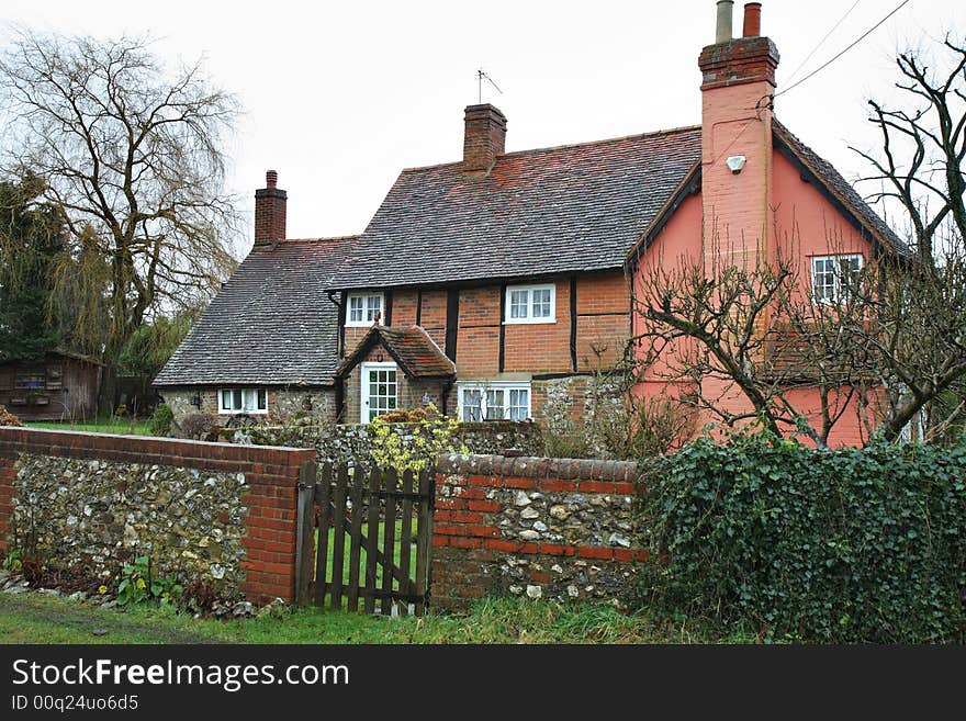 Traditional Timber Framed English Vllage Cottage with a Brick and Flint Wall to the front. Traditional Timber Framed English Vllage Cottage with a Brick and Flint Wall to the front