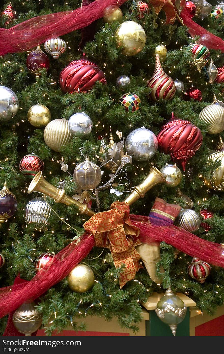 A christmas tree decorated with horns and balls and ribbons. A christmas tree decorated with horns and balls and ribbons