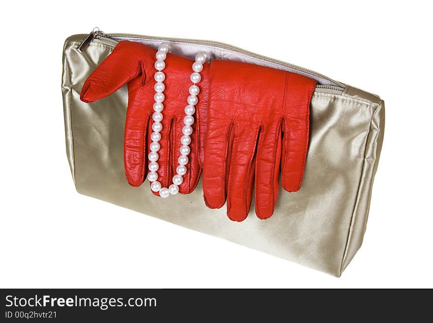 Female bag with gloves and costume jewellery on a white background