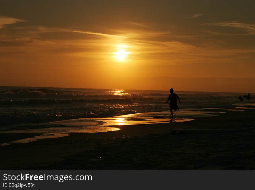 Boy jogging at sunset on beach in florida. Boy jogging at sunset on beach in florida