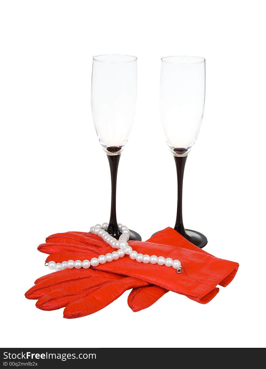 Gloves, glasses and costume jewellery on a white background