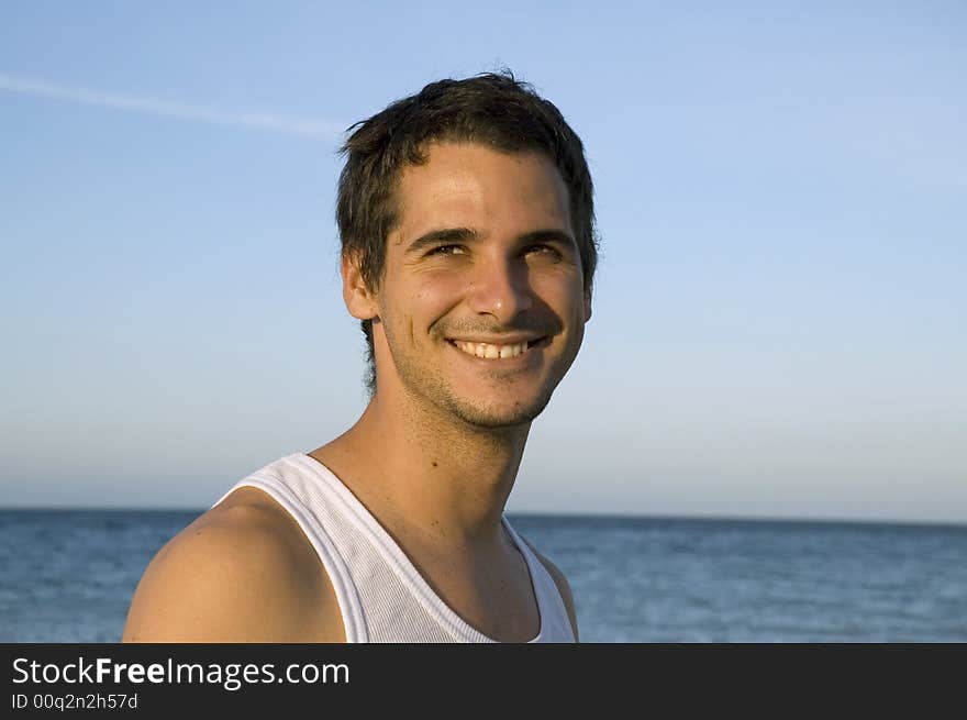 Young happy male on tropical beach background. Young happy male on tropical beach background